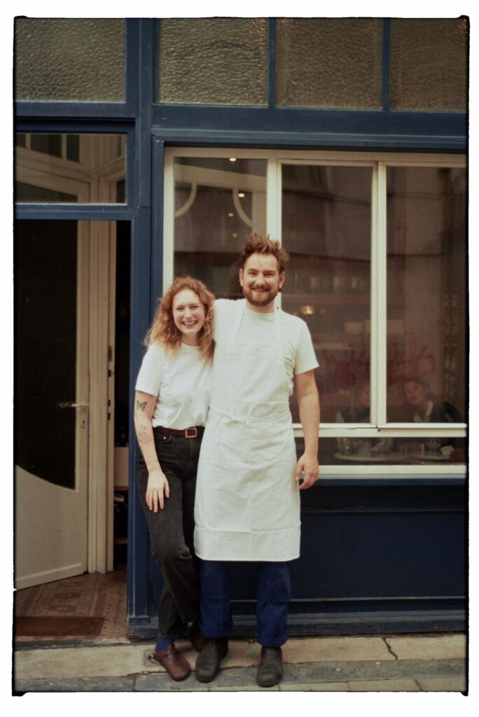 smiling restaurant owners in front of restaurant 